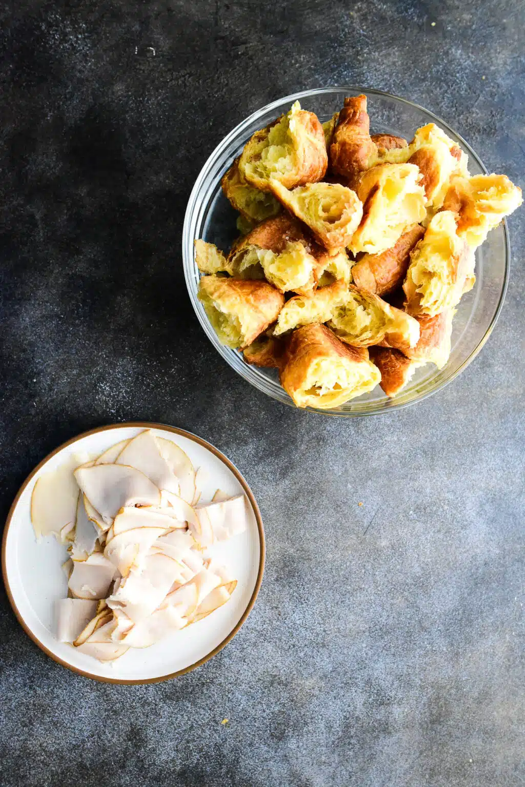 croissant and turkey deli meat torn into pieces