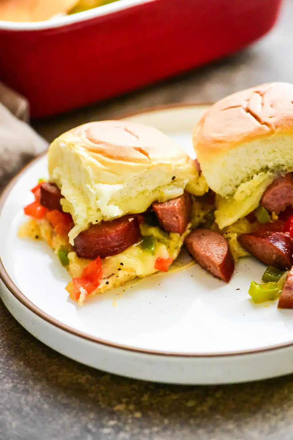 two servings of sausage & pepper sliders on a plate