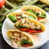 four tuna salad pita pockets on a large serving plate