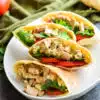 four tuna salad pita pockets on a large serving plate