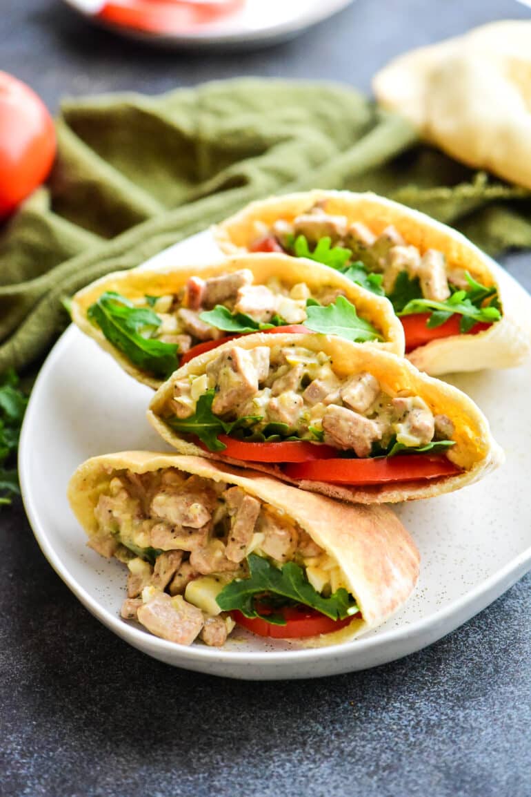 four tuna salad pita pockets on a large serving plate