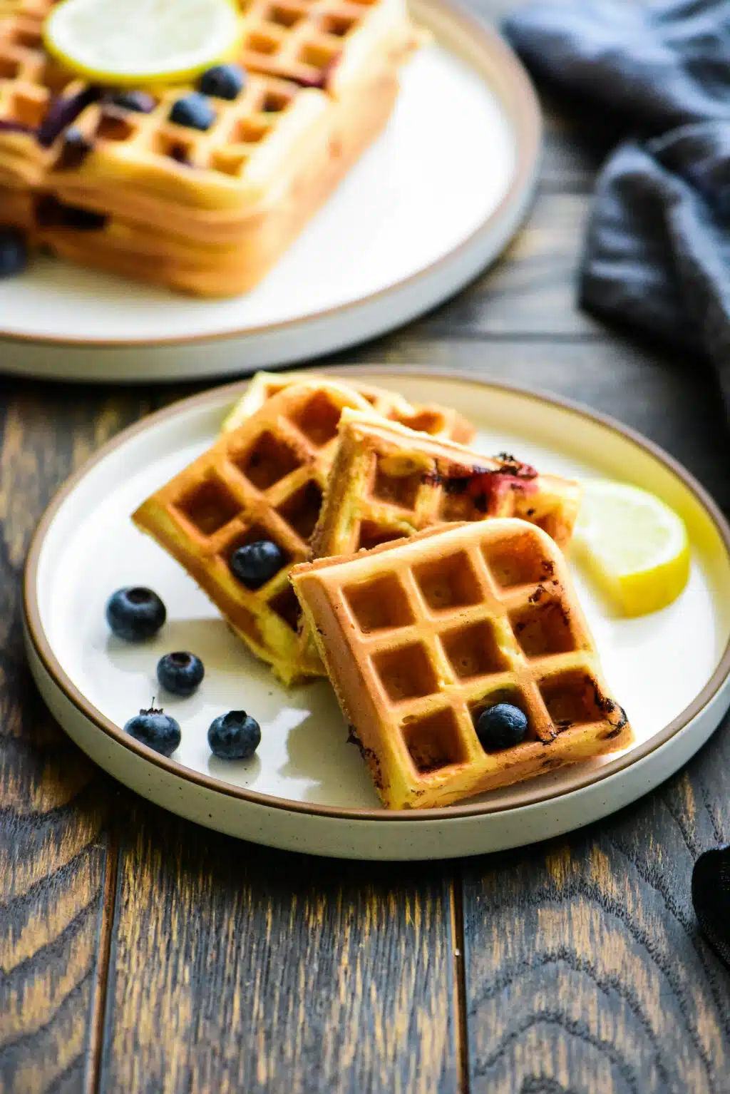 plate of lemon blueberry waffles drizzled without syrup