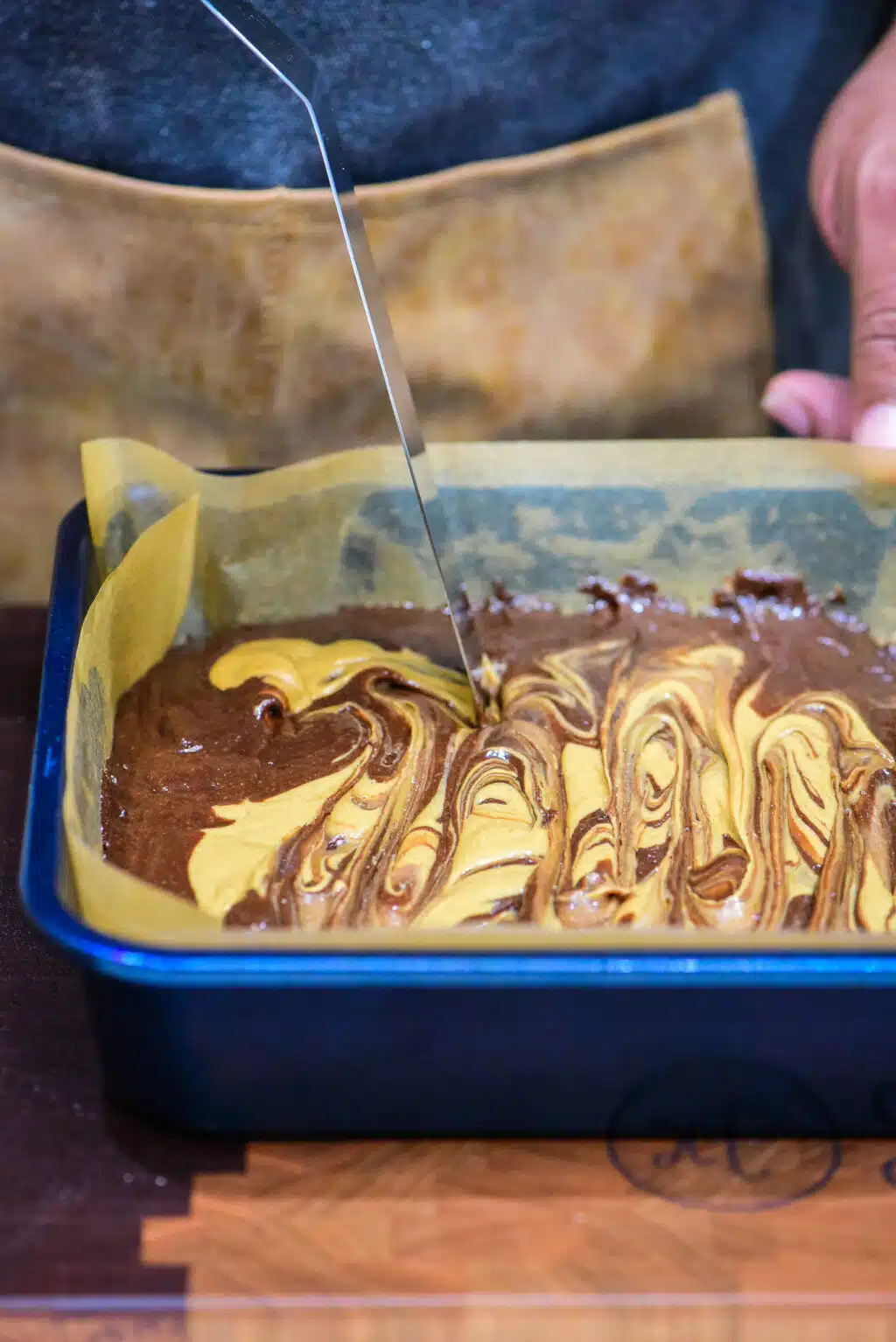 swirling peanut butter on top of the brownie batter