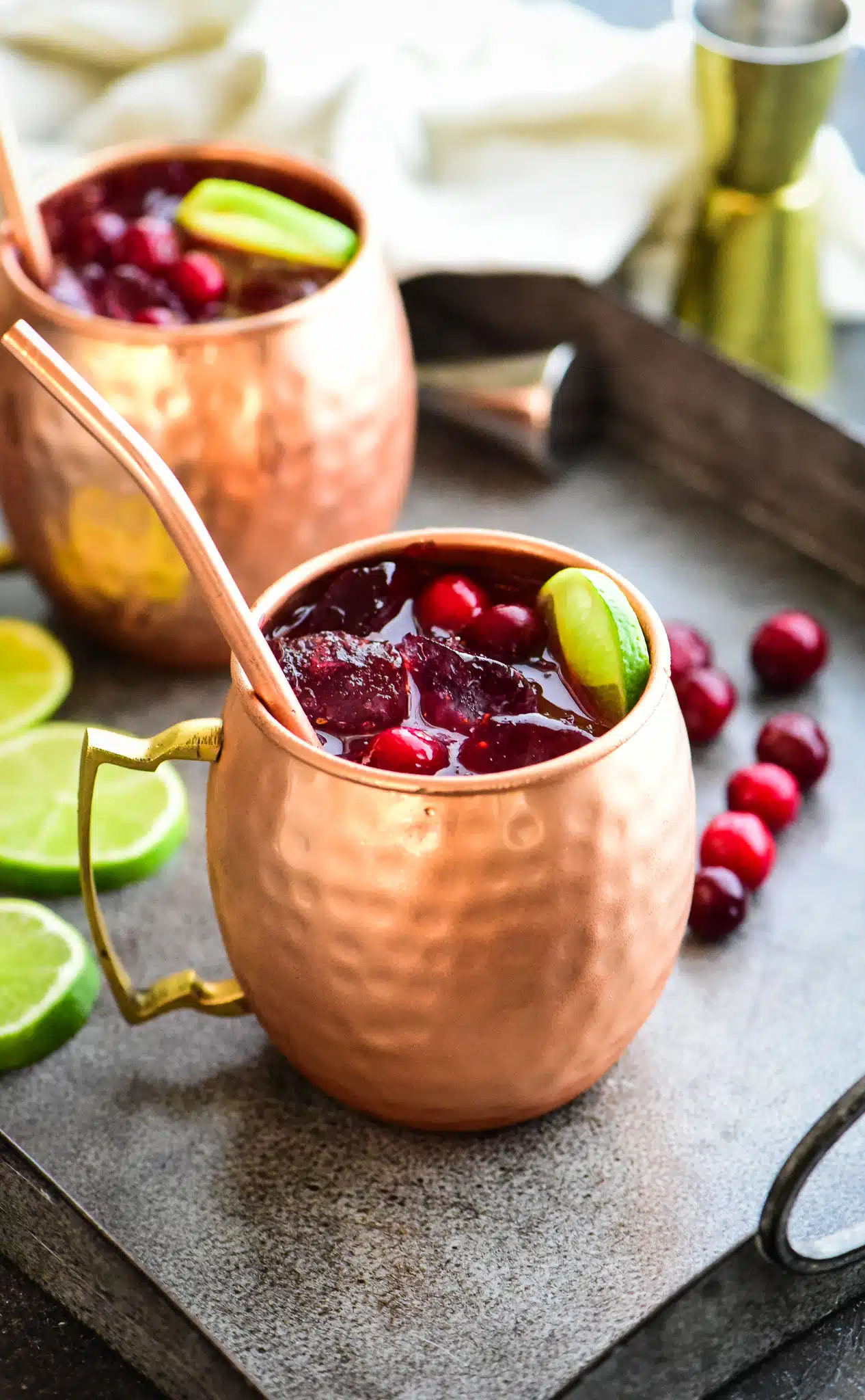 two cranberry Moscow mules served on a gray serving platter