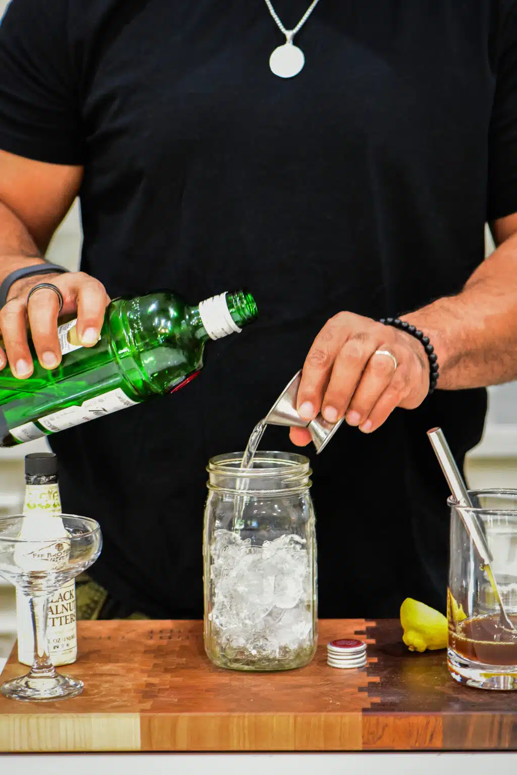 Adding the gin to a cocktail shaker.