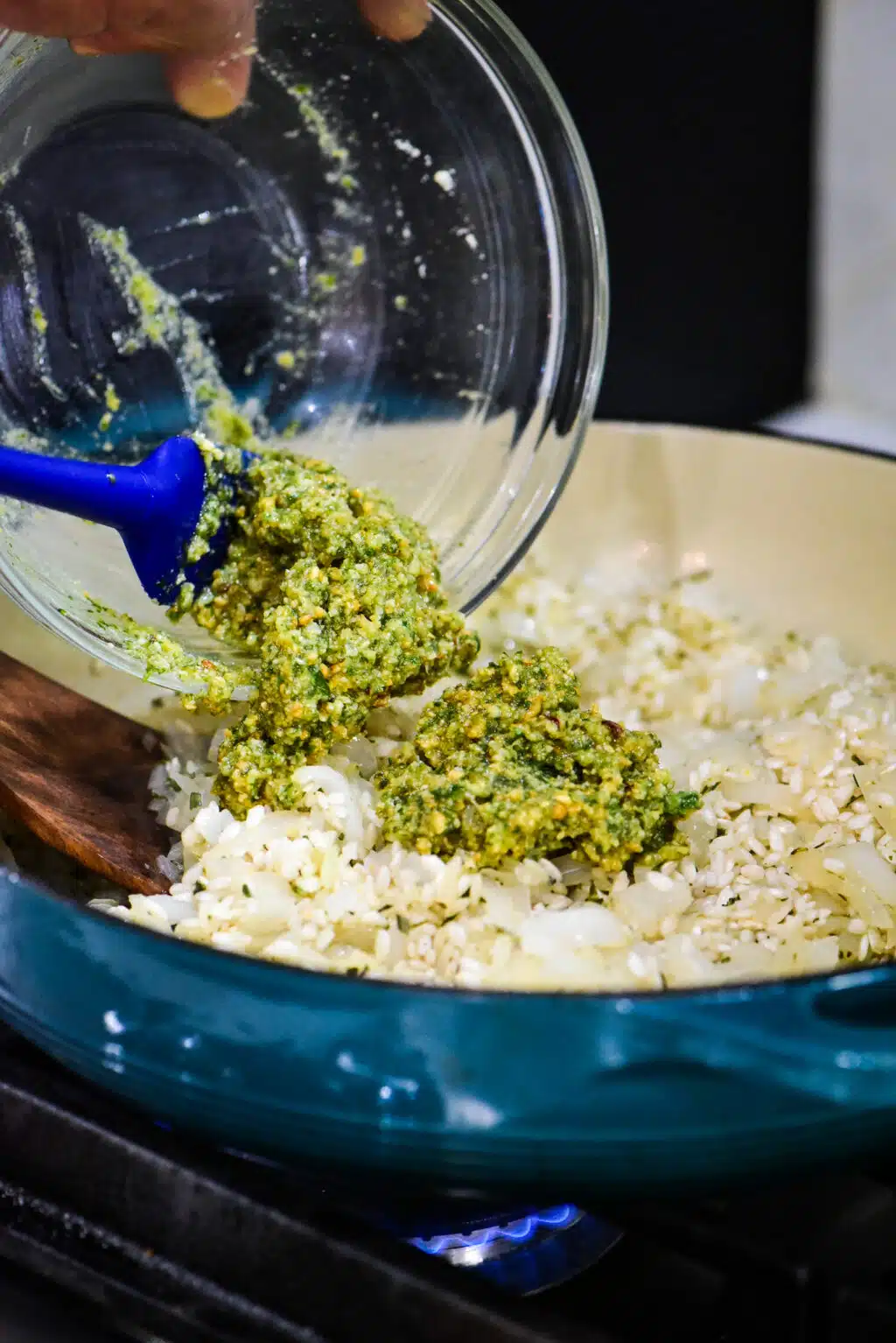 adding the prepared pesto into the Dutch oven with the toasted rice